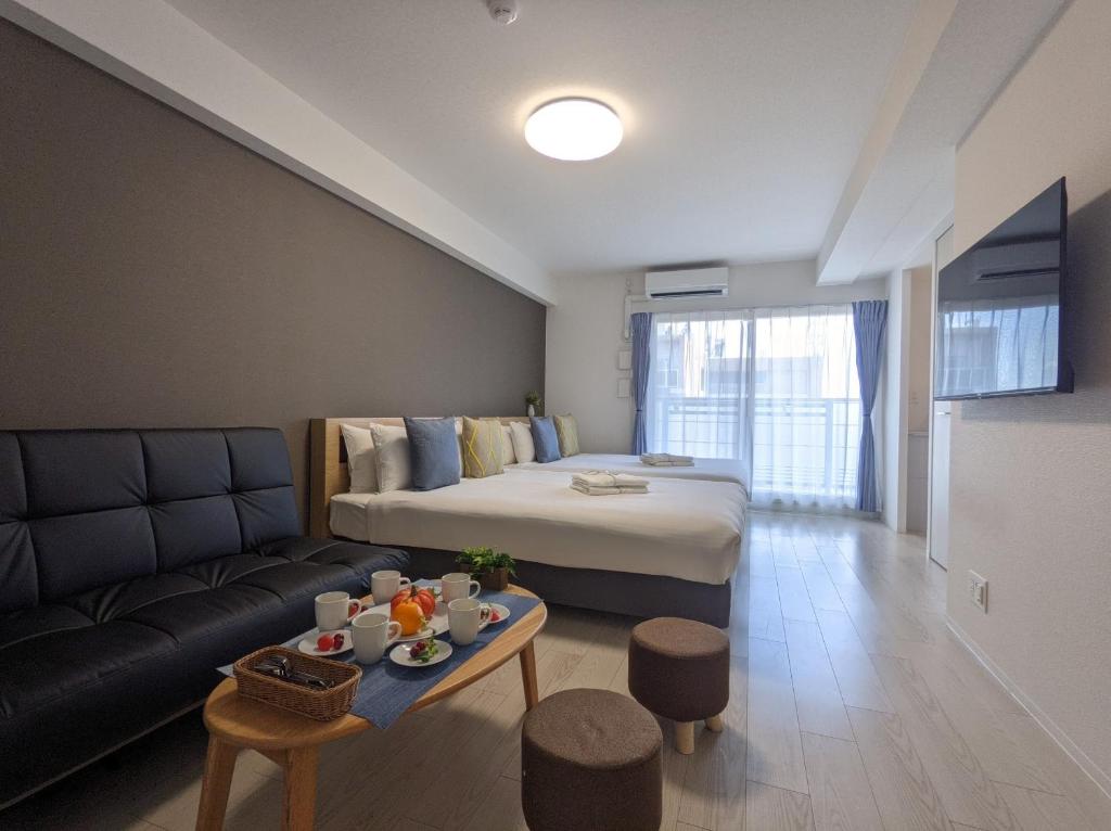 a hotel room with a bed and a couch at ESLEAD HOTEL Osaka Nipponbashi in Osaka