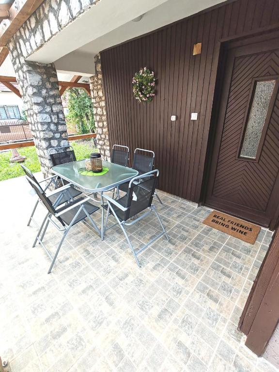 a table and chairs sitting on a patio at Ananász Apartman in Mezőkövesd
