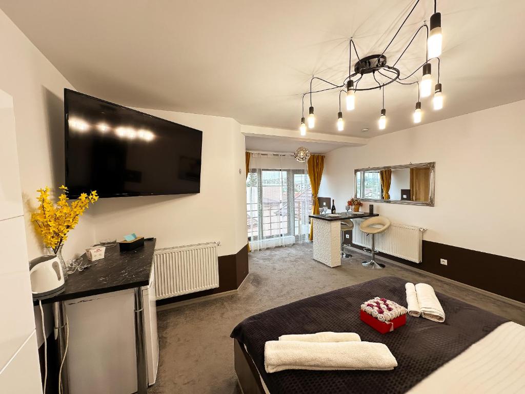 a living room with a large flat screen tv on the wall at Elixir Central Studio with Balcony & Panoramic View in Craiova