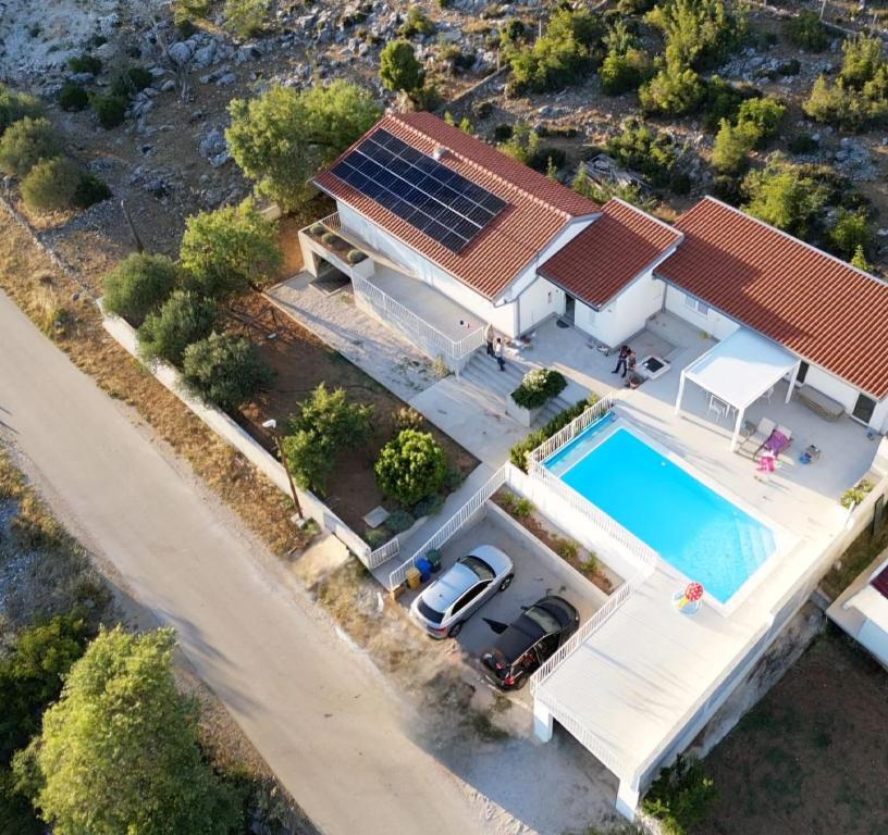 an overhead view of a house with a swimming pool at Villa Velim - Stunning view & Heated private pool in Stankovci