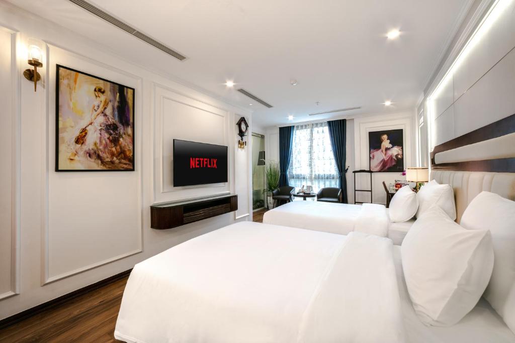 Postel nebo postele na pokoji v ubytování A25 Hotel - 16 Miếu Đầm
