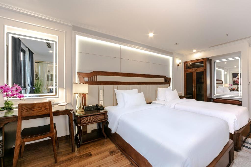 Postel nebo postele na pokoji v ubytování A25 Hotel - 16 Miếu Đầm