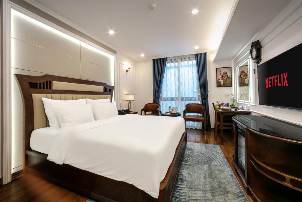 Postel nebo postele na pokoji v ubytování A25 Hotel - 16 Miếu Đầm