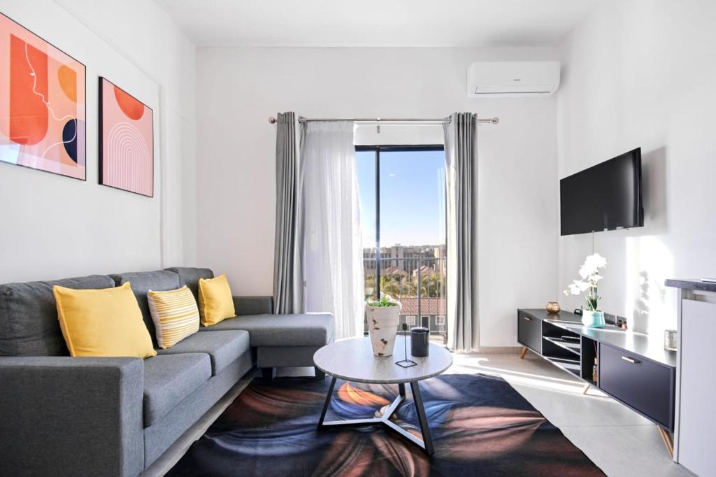 a living room with a couch and a table at The Base Apartment in Johannesburg