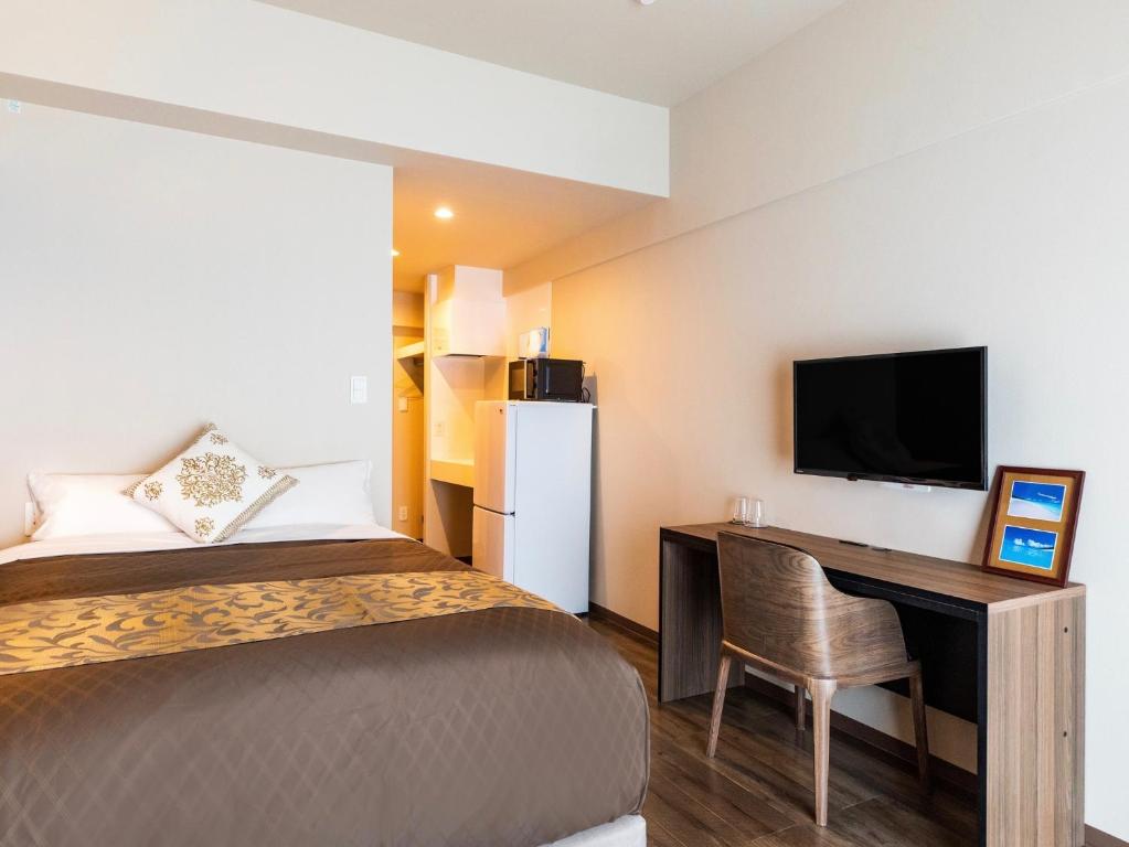 Postel nebo postele na pokoji v ubytování CONDOMINIUM HOTEL Riyuka in KADENA 1