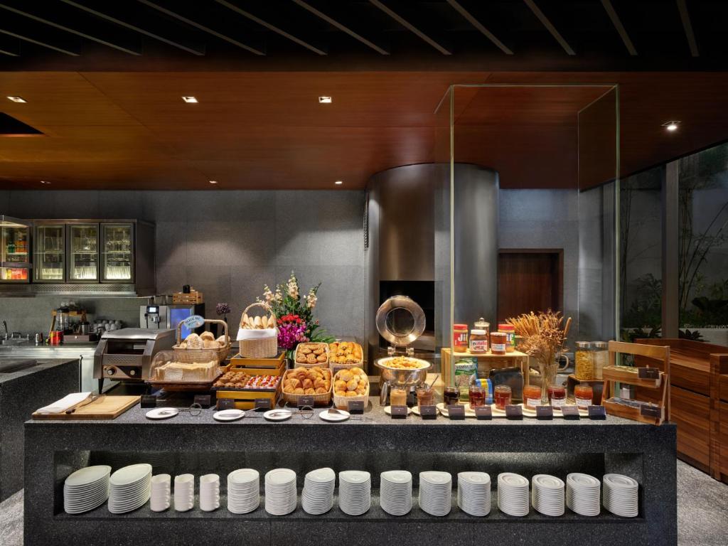 A front-facing view of a pastry, cereal and preserves buffet.