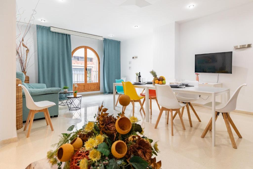 a living room with a table and chairs at Grand Villa Valencia- large groups-8 min to Center by Metro in Valencia