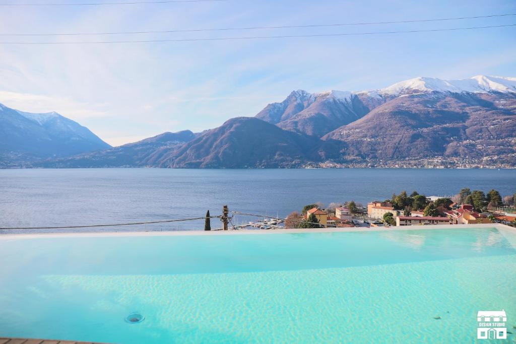 a swimming pool with a view of a lake and mountains at VILLA BELAGO by Design Studio in Bellano