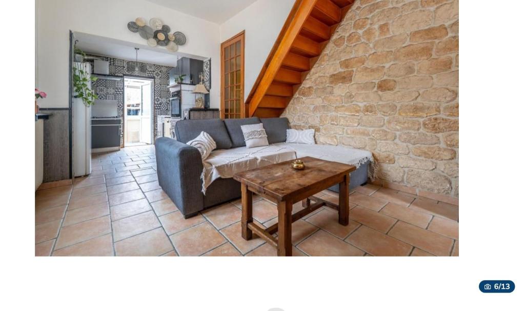 a living room with a couch and a table at Jolie maison in La Courneuve