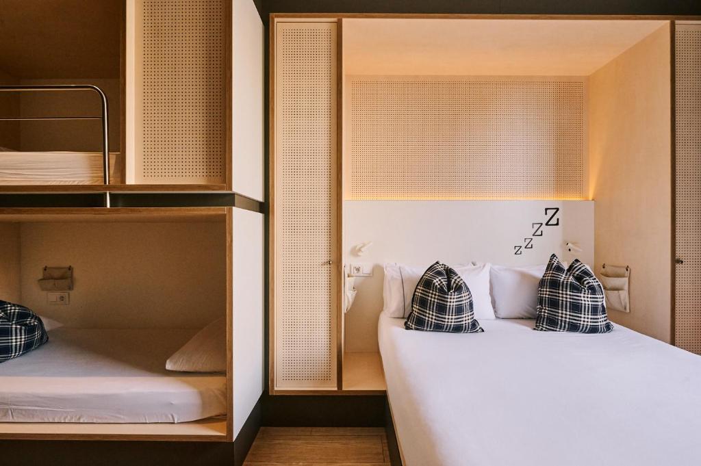 two pillows on a bed in a room at TOC Hostel Barcelona in Barcelona