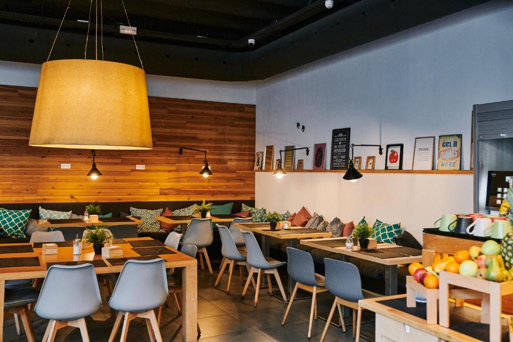 a restaurant with wooden walls and tables and chairs at TOC Hostel Barcelona in Barcelona