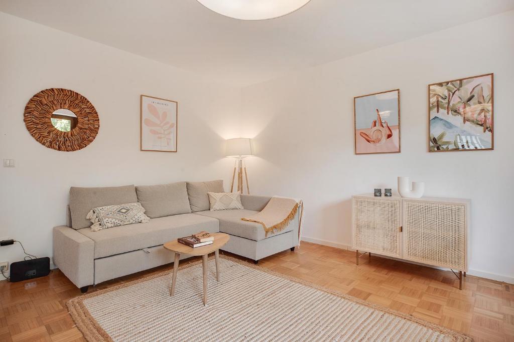 a living room with a couch and a table at Ferienwohnung mit Garten am Chiemsee in Prien am Chiemsee