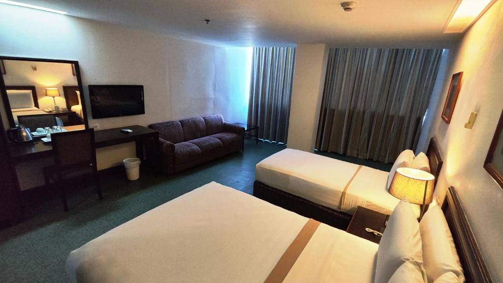 Postel nebo postele na pokoji v ubytování Rajah Park Hotel by Hiverooms