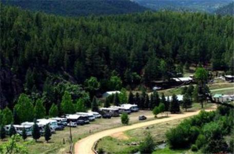 an aerial view of a parking lot with parked cars at Sierra Bonita Cabins and RV Park in Guadalupita