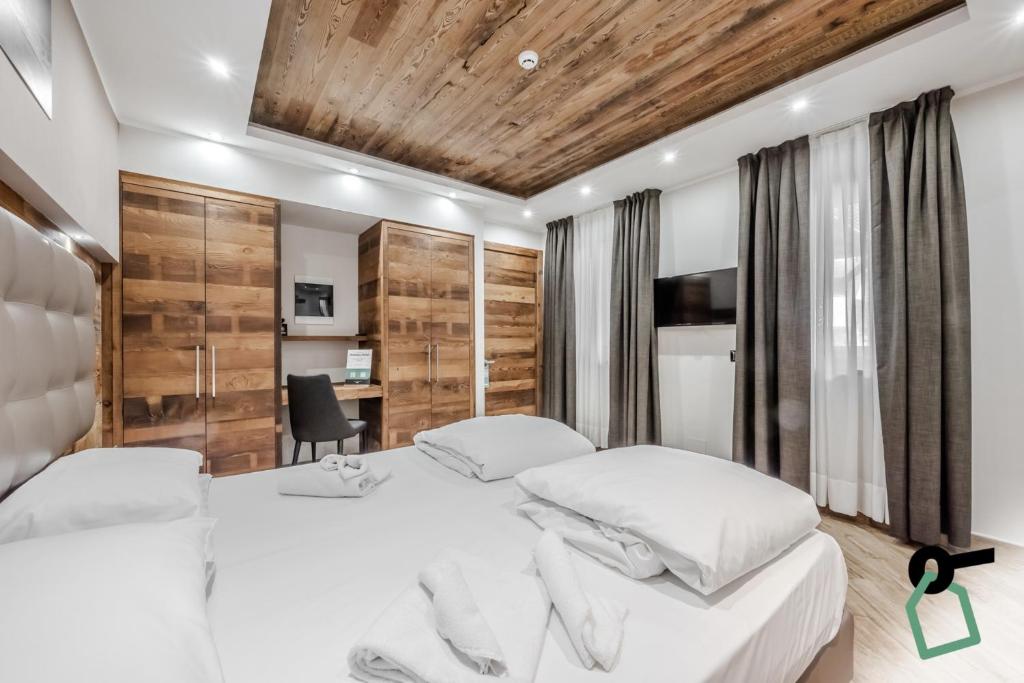 Postel nebo postele na pokoji v ubytování Hotiday Room Collection - Sauze Assietta