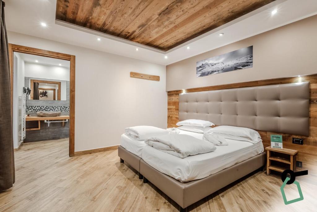 Postel nebo postele na pokoji v ubytování Hotiday Room Collection - Sauze Assietta