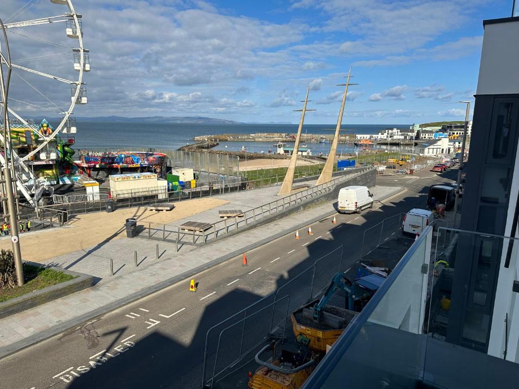 a view of a street with a ferris wheel at Ocean Breeze Apartment in Portrush