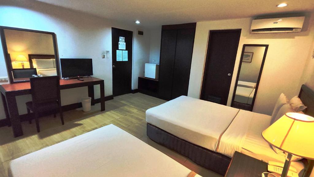 Postel nebo postele na pokoji v ubytování Rajah Park Hotel by Hiverooms