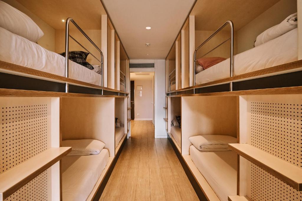 a room filled with lots of bunk beds at TOC Hostel Barcelona in Barcelona