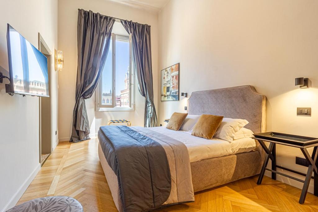 a bedroom with a bed and a large window at Casa Galatea in Canton de Fiori in Bologna