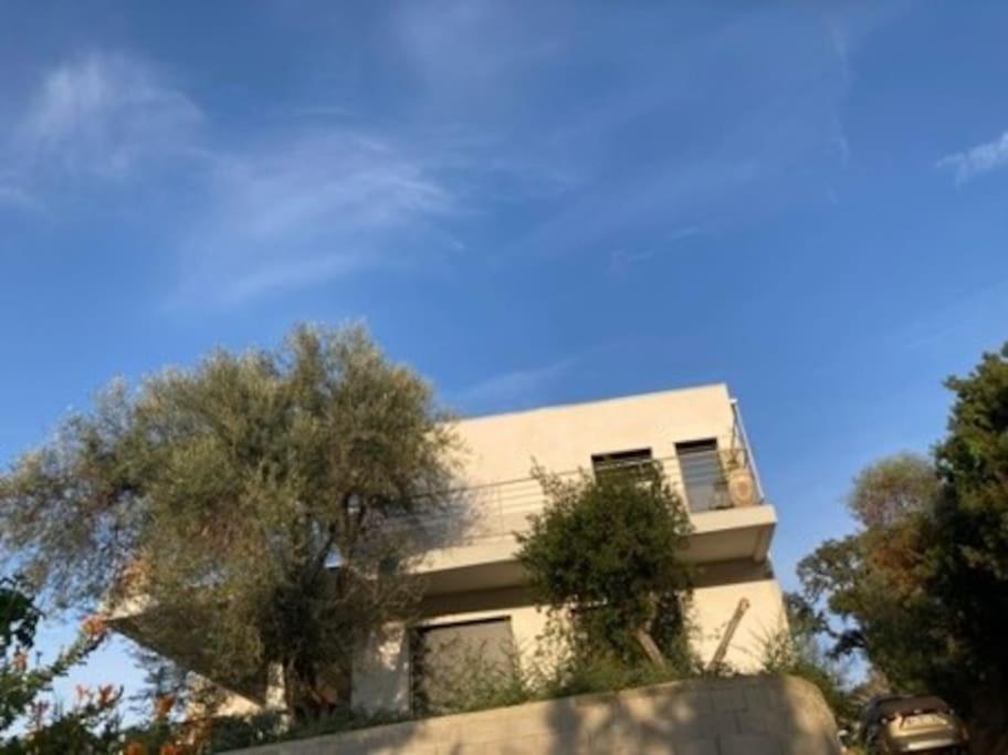 a white building with trees in front of it at Cavalière - RdJ villa 600m plage, 2 ch 6 pers, 3 étoiles grand confort in Le Lavandou