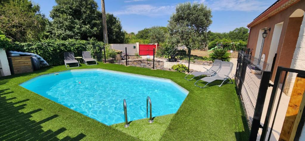- une piscine au milieu d'une cour avec des chaises dans l'établissement Villa familliale au calme sans vis à vis, Bbq, piscine privée, proche de la mer, à Saint-Thibéry
