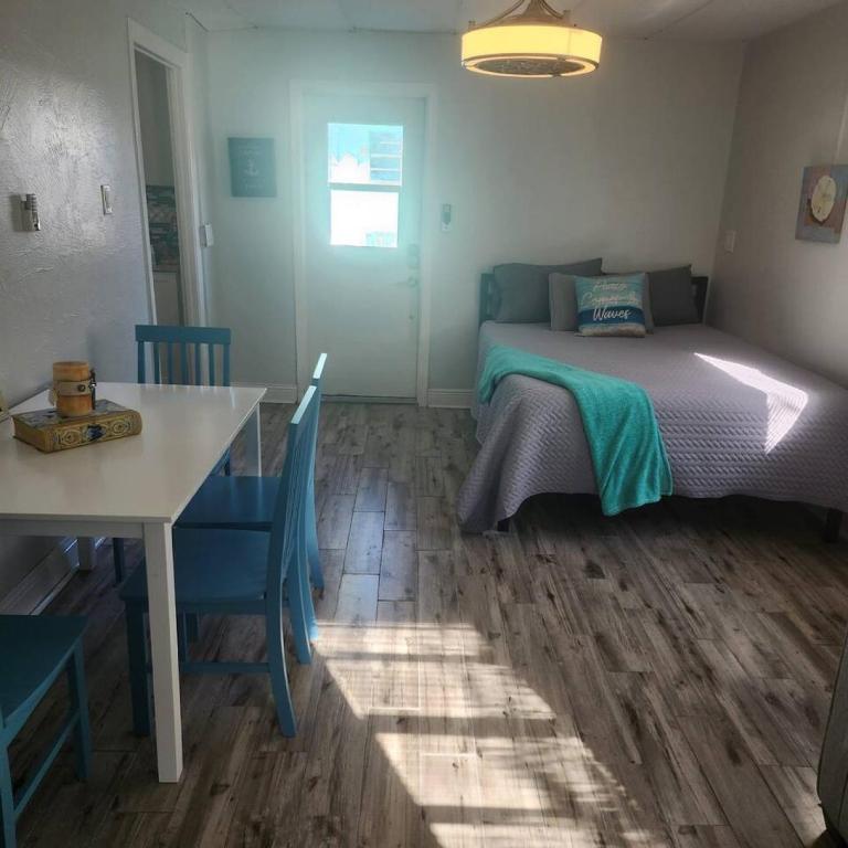 a bedroom with a bed and a table and a table and chairs at Walk to North Beach in Clearwater Beach