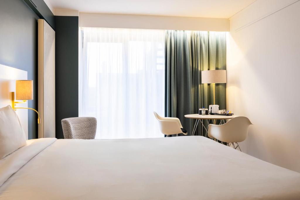 Postel nebo postele na pokoji v ubytování Hotel Louise