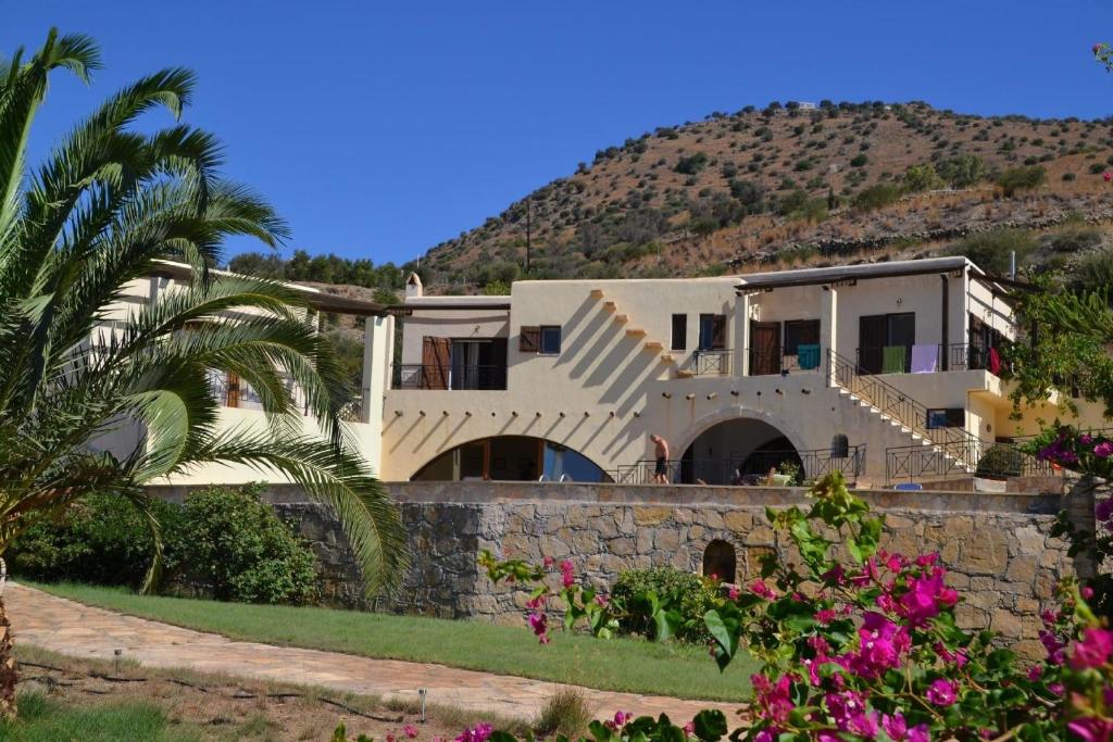 une maison sur une colline avec des fleurs roses dans l'établissement Ferienhaus mit Privatpool für 12 Personen in Agia Galini, Kreta, à Agia Galini