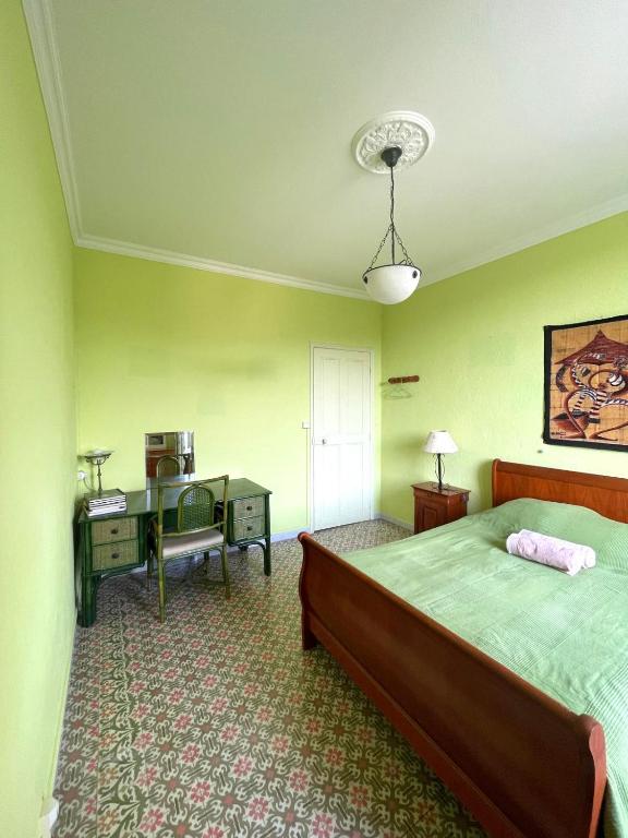 une chambre avec un lit et un bureau avec un ordinateur dans l'établissement Chambre de 1 personne dans Mas de Lubéron, à Robion