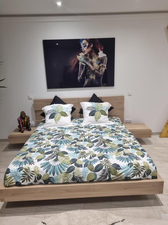 a bedroom with a bed with a blue and white comforter at Love Room in Bassan