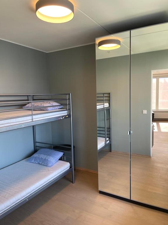 a room with two bunk beds and a mirror at Penthouse apartment - Lillestrøm in Lillestrøm