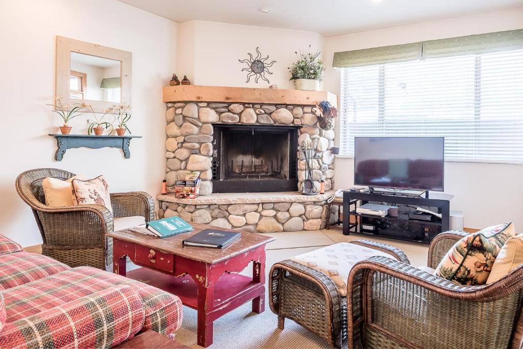 a living room with a fireplace and a tv at Bridgepoint Condo 11 in Ketchum