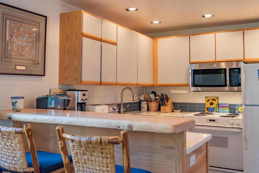 a kitchen with a counter top and a refrigerator at Edelweiss Condo 223B in Ketchum