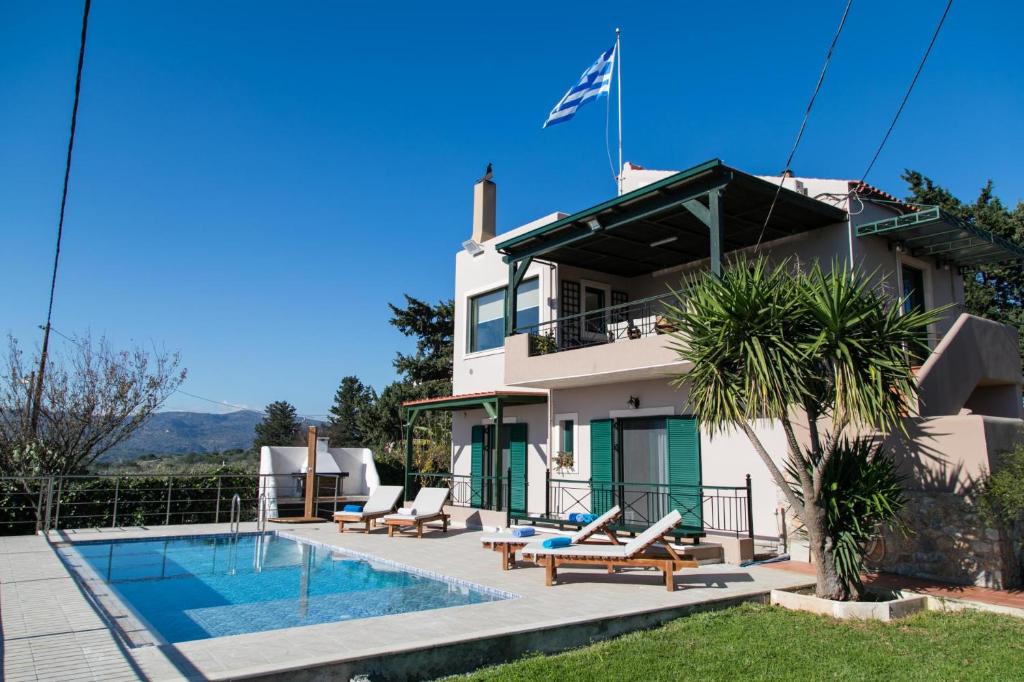 a villa with a swimming pool and a house at Villa Aloni in Chania in Káïna