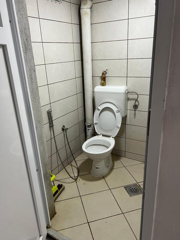 a bathroom with a white toilet in a stall at Apartment rebl Breza in Breza