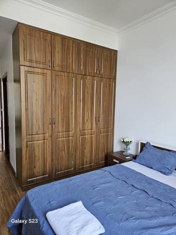 una camera con letto blu e armadi in legno di lovely 2 bed, 2.5 bath condo a Dar es Salaam