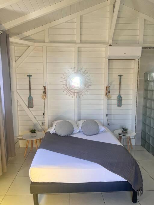 a bedroom with a large bed in a room at Petit bungalow Chez Angelo in Terre-de-Haut