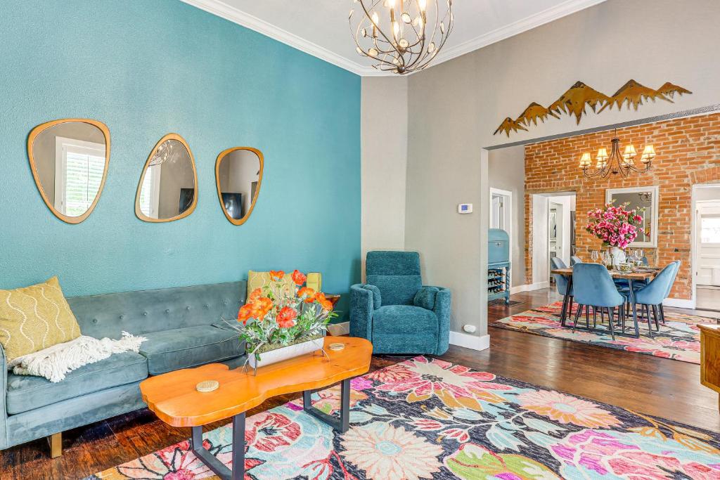 a living room with a couch and a table at Walk to Dtwn Colorful Cañon City Home with Grill! in Canon City