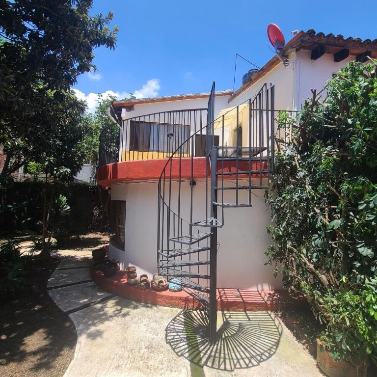a house with a spiral staircase on the side of it at Linda casa en Tepoztlan centro 2 in Tepoztlán