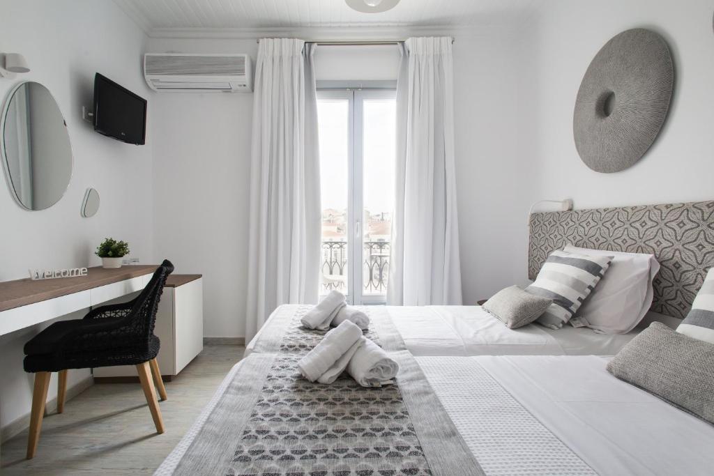 Cama ou camas em um quarto em Aurora - Rooms & Suites - Spetses