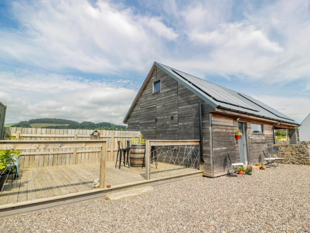 a barn with a deck and a fence at Fasgadh in Perth