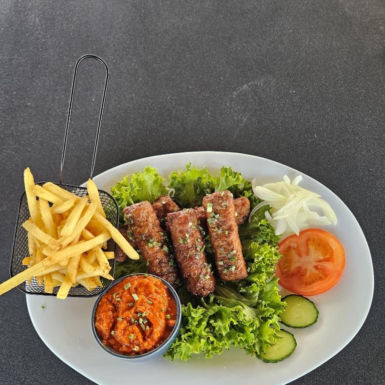 a plate of food with meat and french fries at Hotel Fuchs & Hase SELF CHECK IN in Rosegg