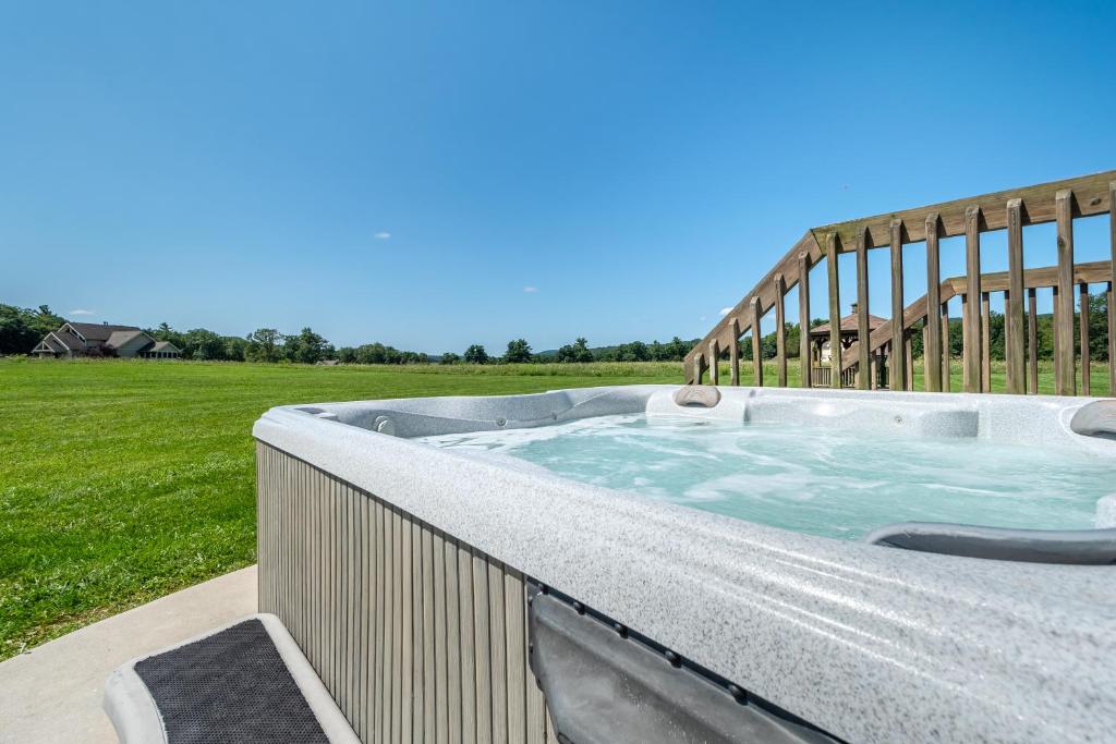a hot tub on a fence with a field in the background at License to Chill in Swanton