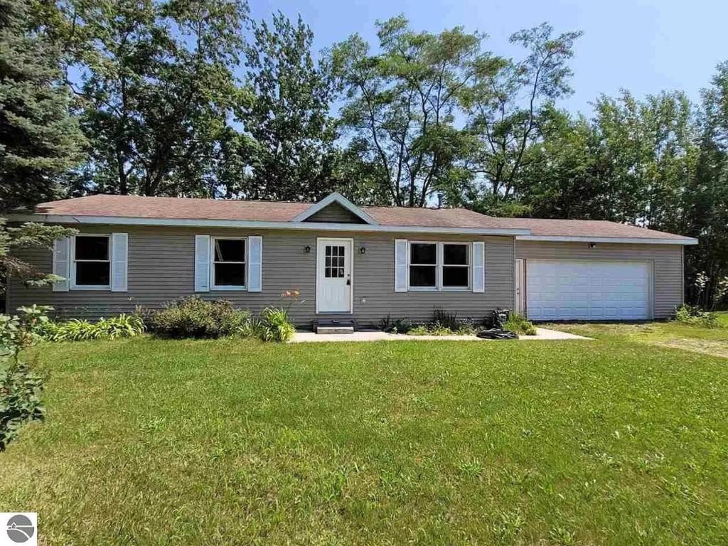 a house with a green lawn in front of it at White Birch - Riverfront And Newly-remodeled! in Elberta