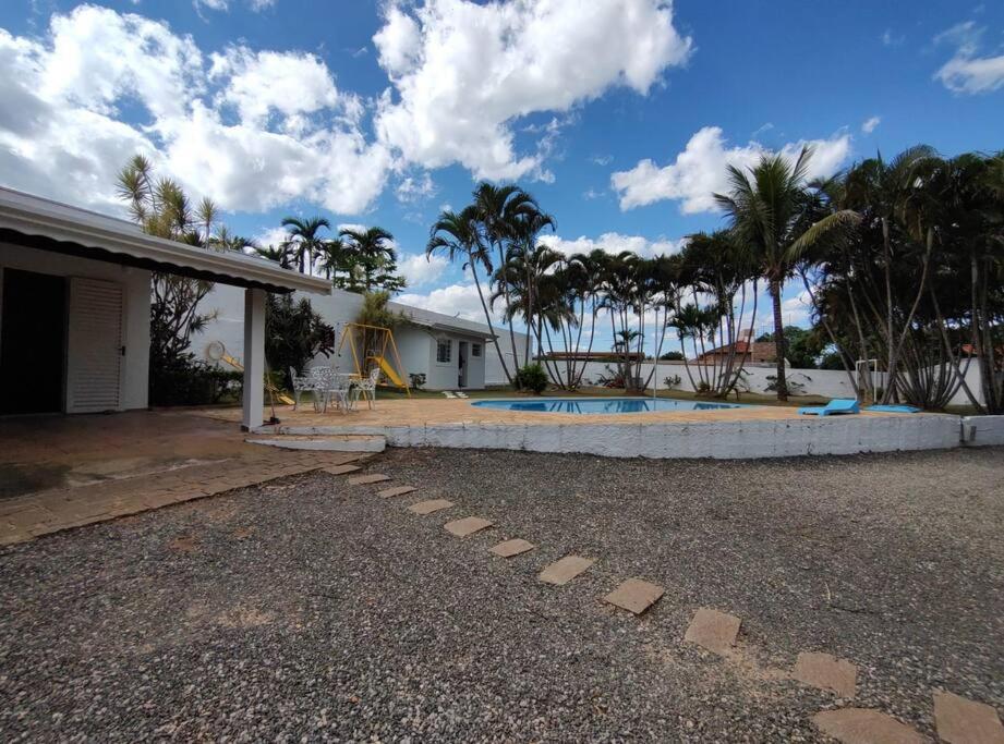 a house with a swimming pool in a yard at Chácara Jatobá in Espirito Santo Do Pinhal