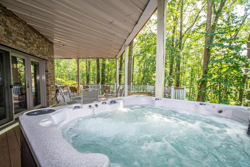 a jacuzzi tub in a house with trees at Lake Dreaming in McHenry