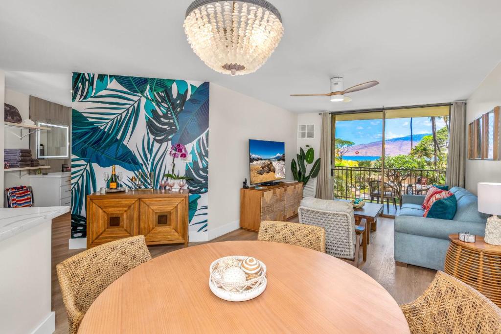 a kitchen and living room with a table and chairs at Hip Hawaiian Oceanfront Vistas in Kihei