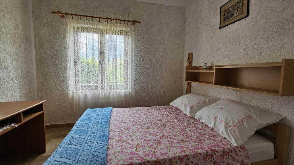 mała sypialnia z łóżkiem i oknem w obiekcie Apartment Pinezici 5319b w mieście Pinezići