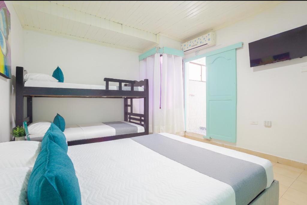 Postel nebo postele na pokoji v ubytování Hostal Familiar Hopen Nel
